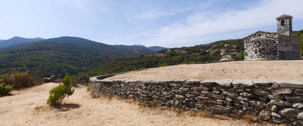 corsica: view of the church of san michele de murato, a small chapel built in the 12th century in polychrome stones and typical pisan romanesque style - black blue escape multi colored imagens e fotografias de stock