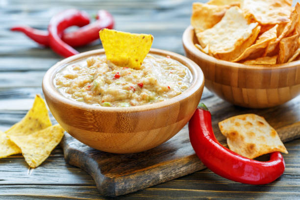 istock Guacamole in a wooden bowl and with tortilla chips. 875014488