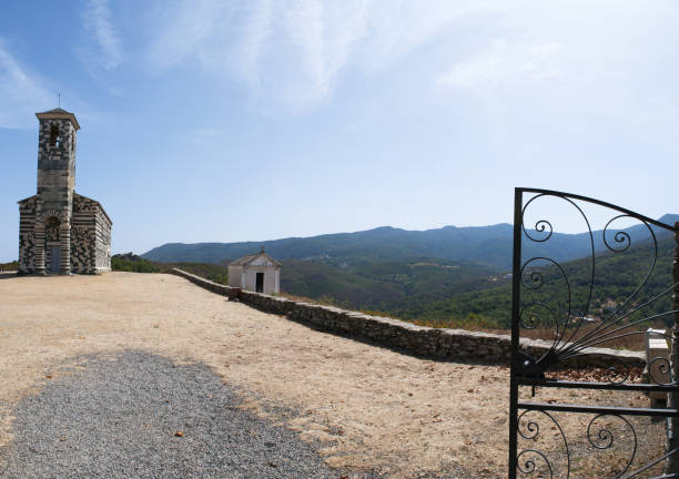 corsica: view of the church of san michele de murato, a small chapel built in the 12th century in polychrome stones and typical pisan romanesque style - black blue escape multi colored imagens e fotografias de stock