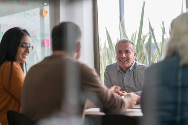 istock Happy man in a business meeting at a creative office 875023952