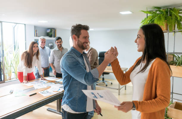 istock Couple of workers giving a high-five at the office 875024086