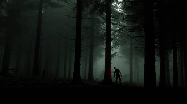 istock single zombie with red shining eyes in green forest 875024172