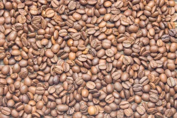 Top view of coffee beans on rustic wooden table