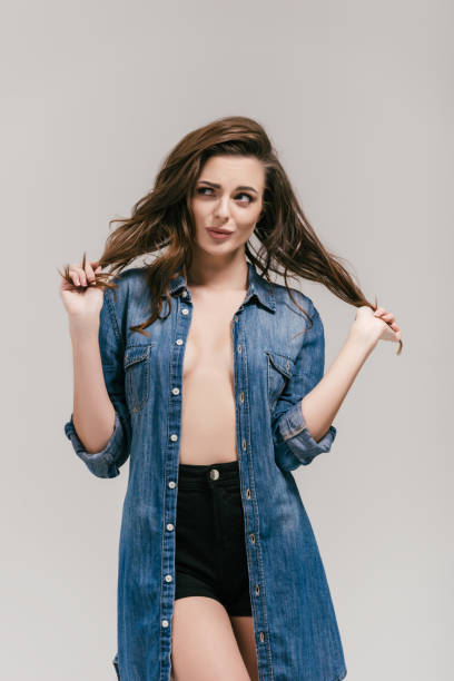 istock seductive girl in denim shirt 875025236