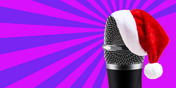 istock Santa Claus Hat on wireless microphone on purple stripes background 875028868