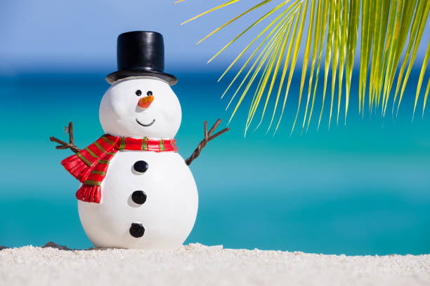 Snowman toy at white sandy beach