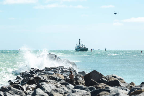 The Icebreaking Arctic Sunrise Leaving Miami The Arctic Sunrise, Greenpeace’s icebreaking research ship, leaving land after been docked in Downtown Miami for several days. The helicopter of the organization itself flies over the ship. greenpeace activists stock pictures, royalty-free photos & images