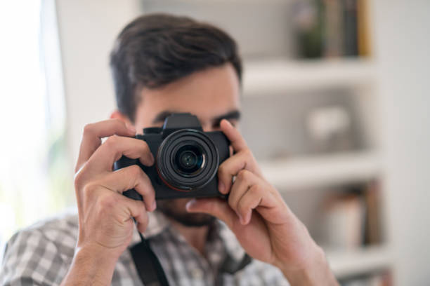 istock Photographer taking a picture with his camera 875031814