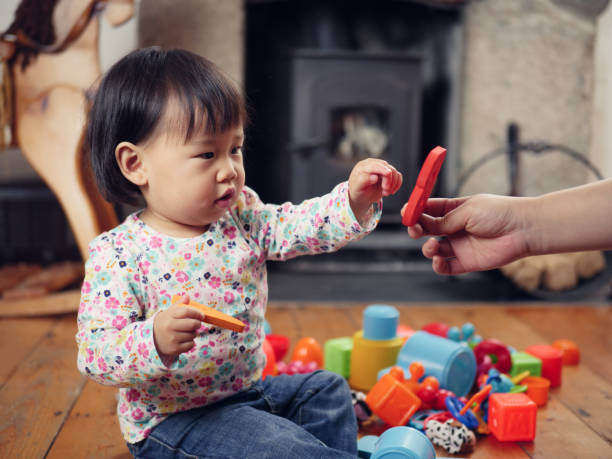 istock baby girl playing alphabet blocks 875032086