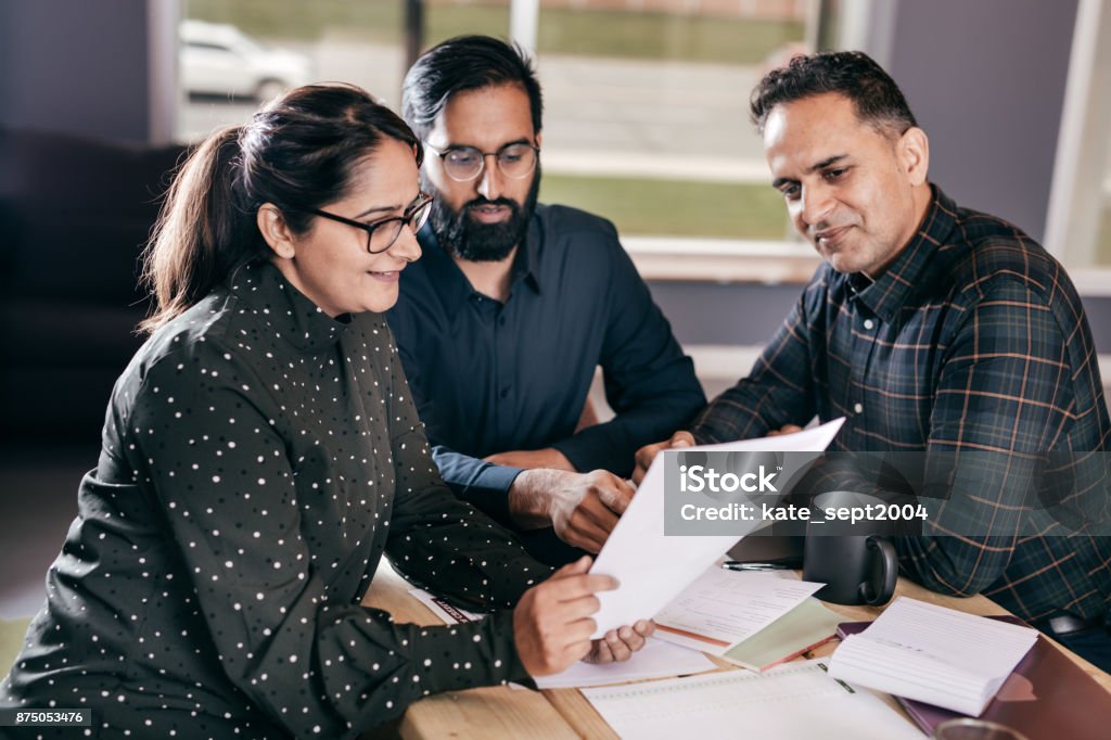 Couple and financial advisor Business group around the table Document Stock Photo
