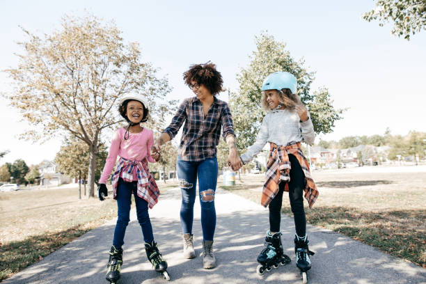 Happy siblings on rollerblades Outdoor activities and siblings inline skating stock pictures, royalty-free photos & images