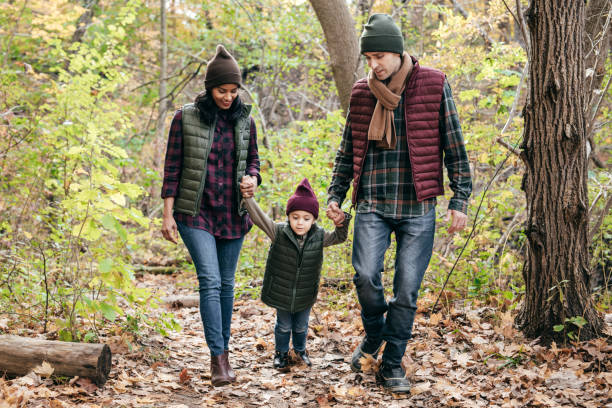 istock Parents and daughter in the park 875053592