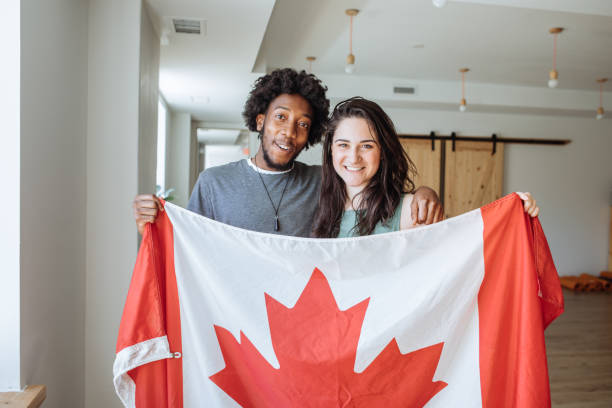 istock Couple holding Canadian Flag 875053652