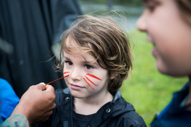 istock child being painted by a local in the amazon 875053944