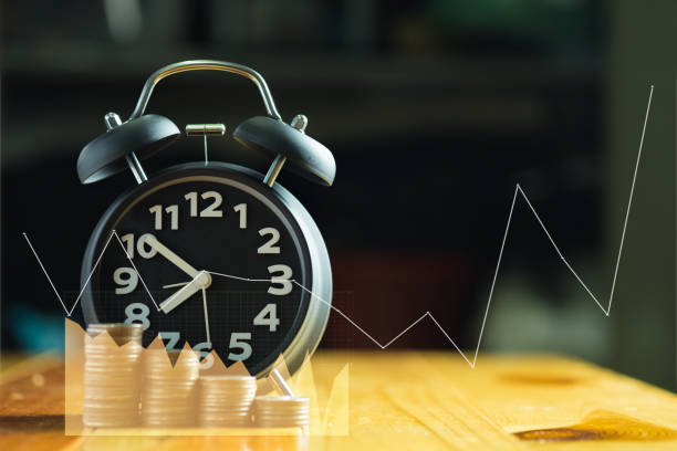 istock Double exposure of Alarm clock and step of coins stacks on working table with financial graph chart, time for savings money concept. 875054084