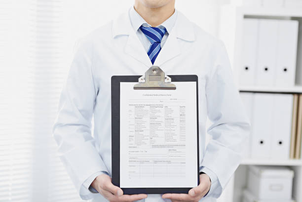 istock Doctor Showing Blank Medical Chart On Clipboard. 875054416