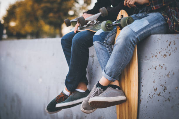 istock Skateboarders taking a rest in skate park 875060684
