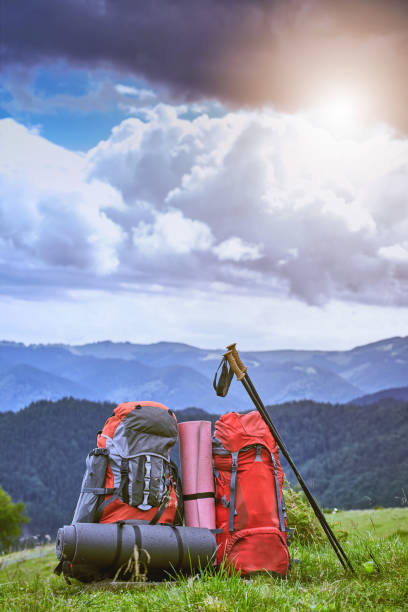 istock Backpacks in the mountains overlooking the mountains on the green grass. 875061146