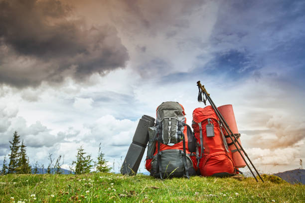 istock Backpacks in the mountains overlooking the mountains on the green grass. 875061148