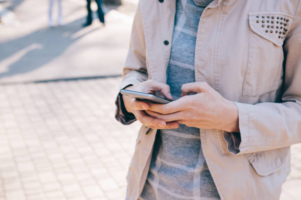 istock Cropped image of mobile phone in female hands 875061682