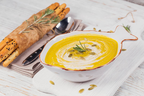 istock Pumpkin soup with cream and pumpkin seeds 875064194