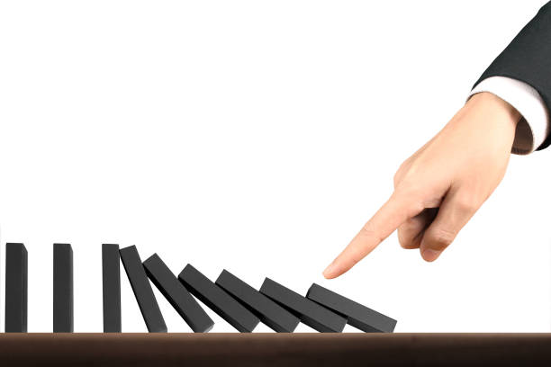 istock Hand Stopping domino concept 875077814