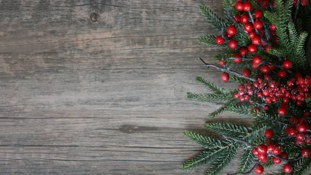 istock Christmas Evergreen Branches and Berries Over Wood Horizontal Background 875081382