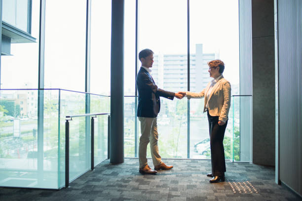 istock Asian business people shaking hands 875084634