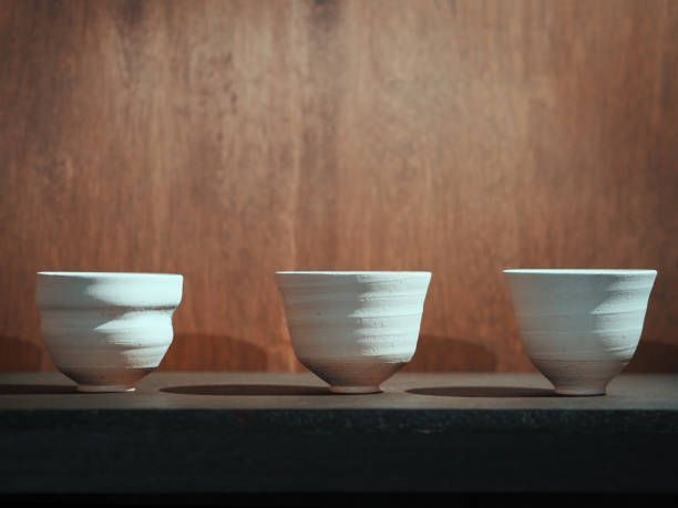 istock Raw clay ceramic bowls on wood table 875087670