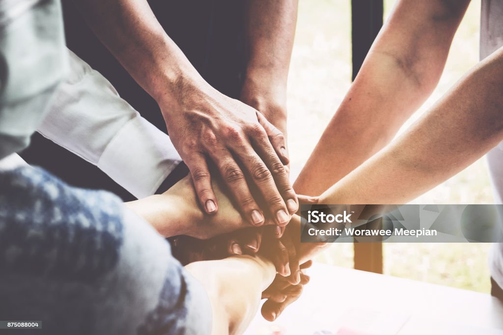 Group of business people putting their hands working together on wooden background in office. group support teamwork agreement concept. Praying Stock Photo