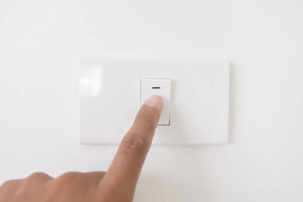 istock Closeup hand turn off a power button,Finger press light button,Hand with Power plug,interior electric power button in home,Concept switch on light 875090246