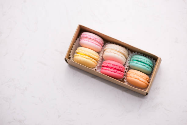 istock Sweet macarons. Different french cookies macaroons in a paper box. 875096844