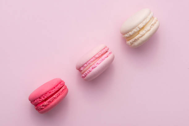 istock Tasty pink cake macaron or macaroon on pink background from above 875096928