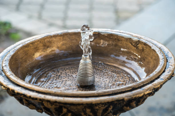 istock Close up water drops flowing from fountain 875099540