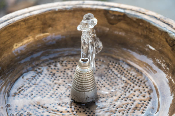 istock Close up water drops flowing from fountain 875100312