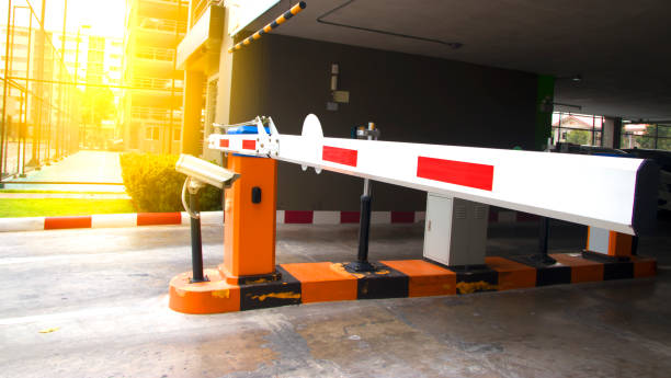istock Security system for building access - barrier gate stop with toll booth, traffic cones and cctv. 875103792