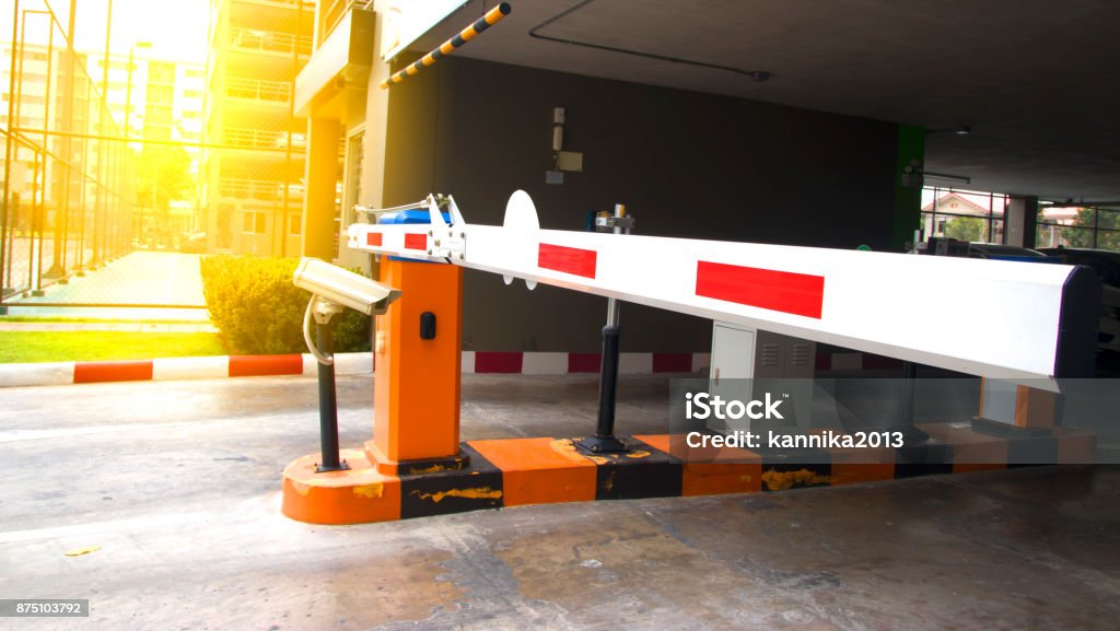 Security system for building access - barrier gate stop with toll booth, traffic cones and cctv. Security system for building access - barrier gate stop with toll booth, traffic cones and cctv Gate Stock Photo