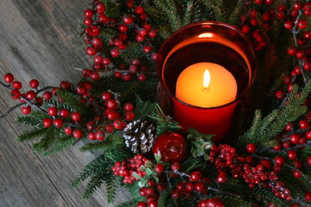 istock Christmas Candle with Pine Tree Branches and Berries Over Rustic Wood 875106694