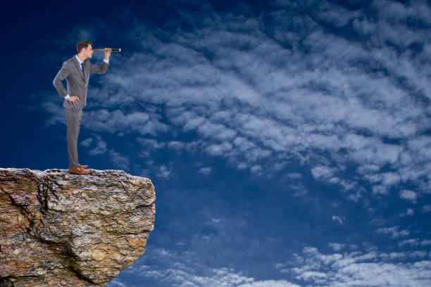 istock Businessman searching through telescope 875110140