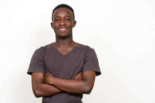 istock Young African man wearing brown shirt against white background 875110548