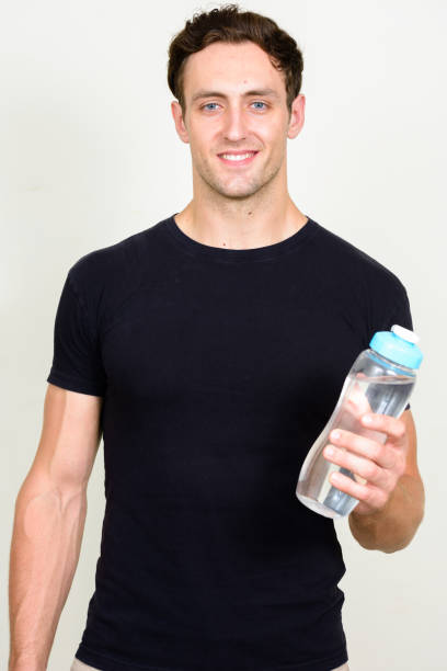 istock Young handsome man with curly hair ready for gym against white background 875113370