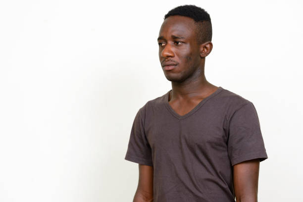 istock Young African man wearing brown shirt against white background 875113856