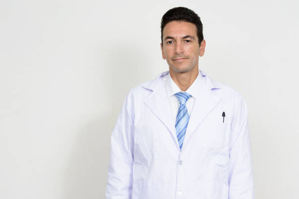 Portrait of mature handsome man doctor against white background