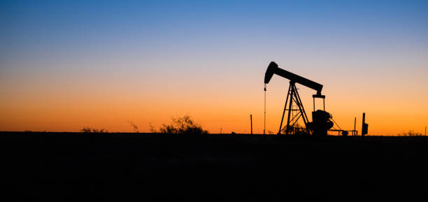 istock Texas Oil Pump Jack Fracking Crude Extraction Machine Sunset 875114716
