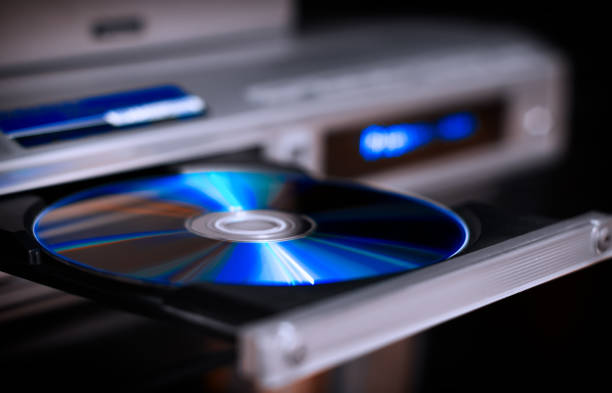 DVD disc inserting to player stock photo