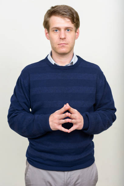 istock Young handsome man blue sweater against white background 875117056
