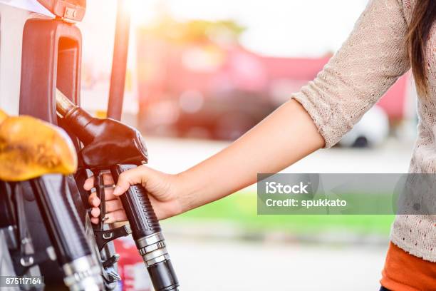 Closeup Of Woman Hand Holding A Fuel Pump At A Station Stock Photo - Download Image Now