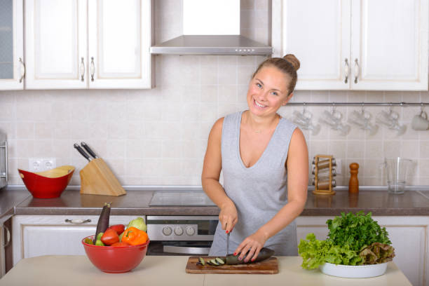 istock Happy woman cooking salad 875117702