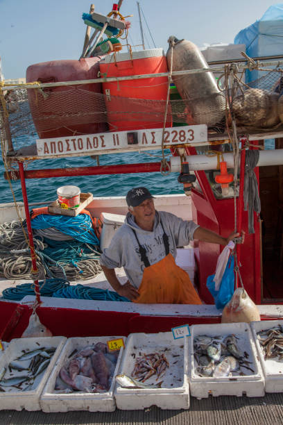 Ermoupolis  - November 15 : Main harbour of Ermoupolis the fishing boats have returned to sell their fresh fish on the dock. Ermoupolis 15, 2017 Syros Greece.