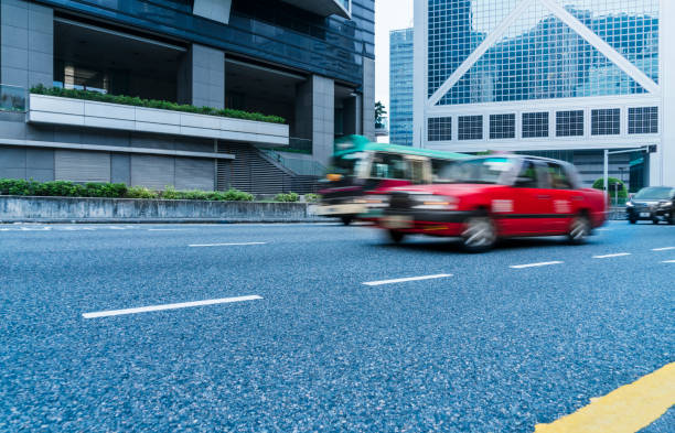 istock red cabs driving on urban street 875125072